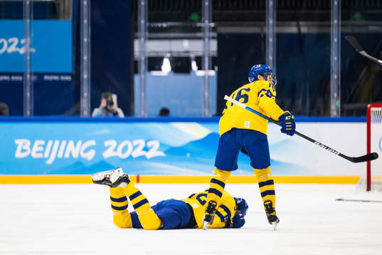 Philip Holm of Sweden in pain in an ice hockey preliminary