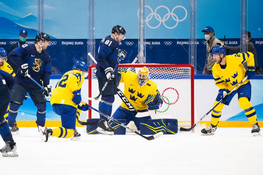 Iiro Pakarinen of Finland and goaltender Magnus Hellberg of
