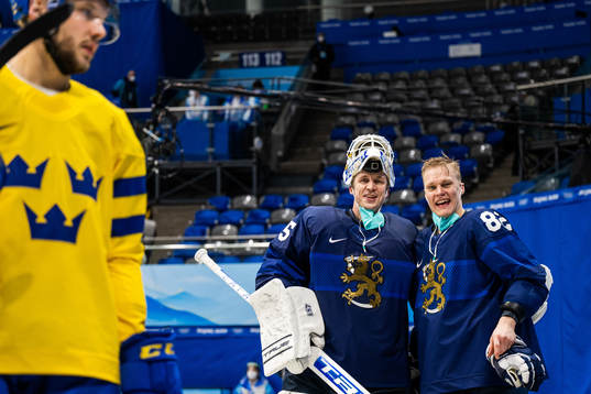 goaltender Jussi Olkinoura and Harri Pesonen of Finland