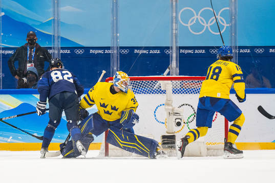 Harri Pesonen of Finland scores 4-3 behind goaltender
