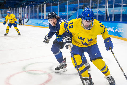 Sami Vatanen of Finland and Max Friberg of Sweden in an ice