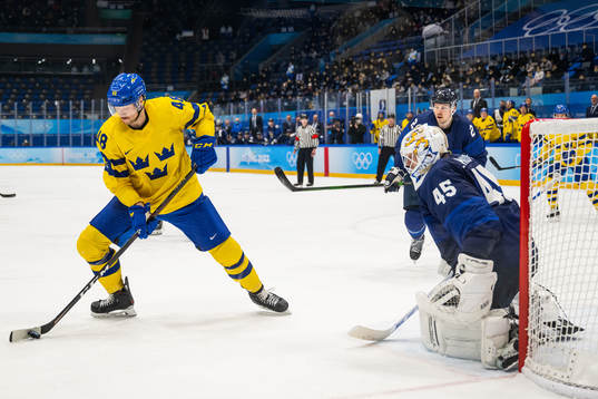 Carl Klingberg of Sweden and goaltender Jussi Olkinoura of