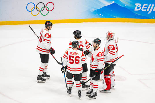 Players of Canada celebrate with goaltender Matt Tomkins in