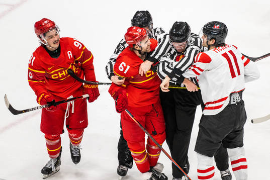 Wei Ruike of China and Jack McBain of Canada in an ice