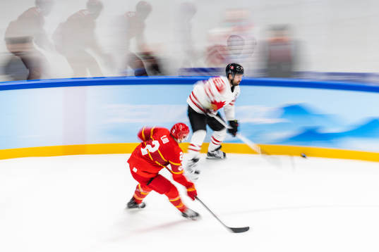 Liu Jie of China and David Desharnias of Canada in an ice