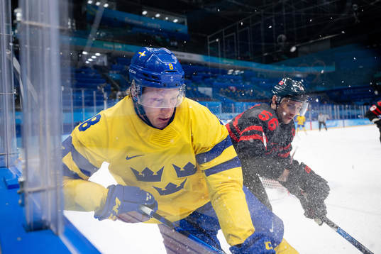 Fredrik Olofsson of Sweden and Maxim Noreau of Canada in