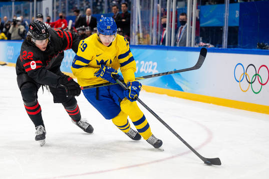 Owen Power of Canada and Pontus Holmberg of Sweden in the