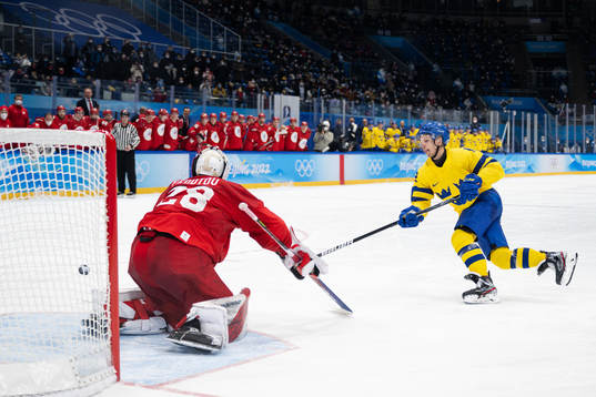 Goaltender Ivan Fedotov of Russia and Max Friberg of Sweden