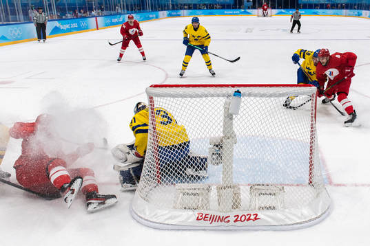 Pavel Karnaukhov of Russia and goaltender Lars Johansson of