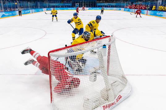 Pavel Karnaukhov of Russia in a collision with goaltender