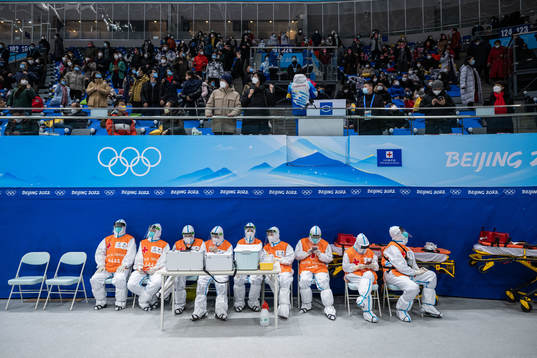 Spectators and medical personel in full protective