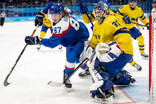 Pavol Regenda of Slovakia and goaltender Lars Johansson of