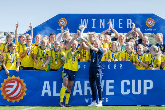 Players of Sweden celebrate with the trophy