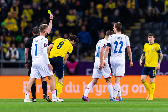 Albin Ekdal of Sweden receives a yellow card from referee
