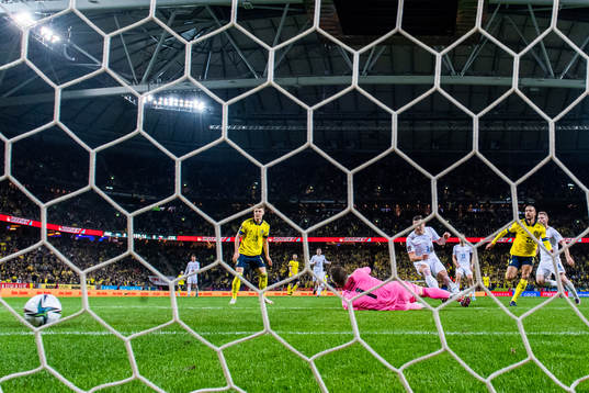 Robin Quaison of Sweden scores 1-0 behind goalkeeper Tomas