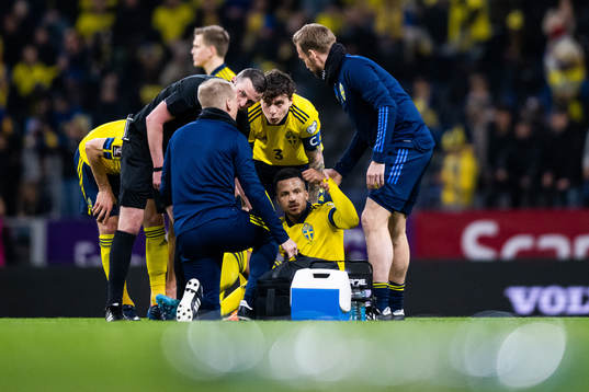 Martin Olsson of Sweden receives medical attention