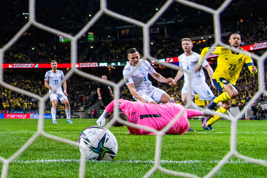Robin Quaison of Sweden scores 1-0 behind goalkeeper Tomas