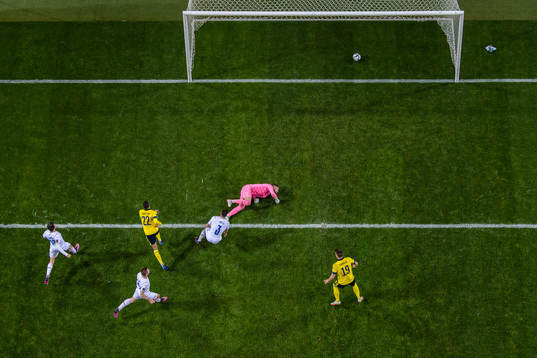 Robin Quaison of Sweden scores the 1-0 goal behind