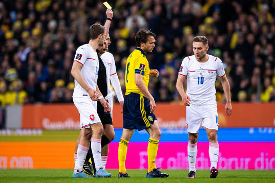 Albin Ekdal of Sweden receives a yellow card from referee
