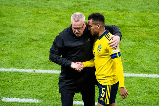 head coach Janne Andersson greets Martin Olsson of Sweden
