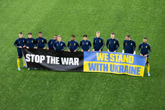 Players of Sweden with a banner