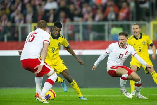 Alexander Isak of Sweden against Kamil Glik and Matty Cash