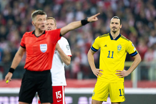 Referee Daniele Orsato and Zlatan Ibrahimovic  of Sweden