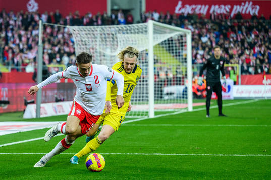 Matty Cash of Poland and Emil Forsberg of Sweden
