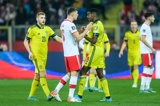 Krystian Bielik of Poland and Alexander Isak of Sweden