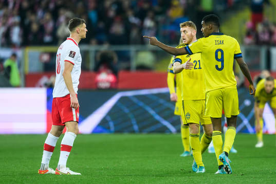 Krystian Bielik of Poland and Alexander Isak of Sweden