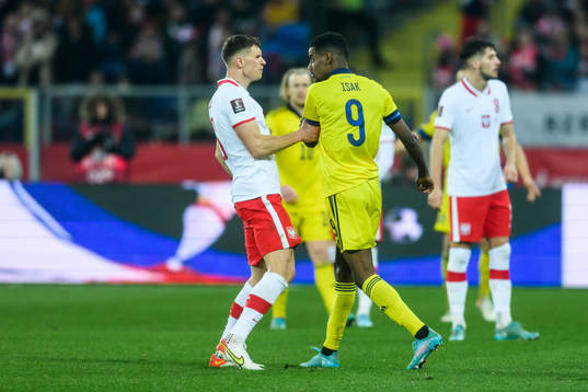 Krystian Bielik of Poland and Alexander Isak of Sweden