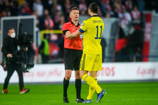 Referee Daniele Orsato and Zlatan Ibrahimovic  of Sweden