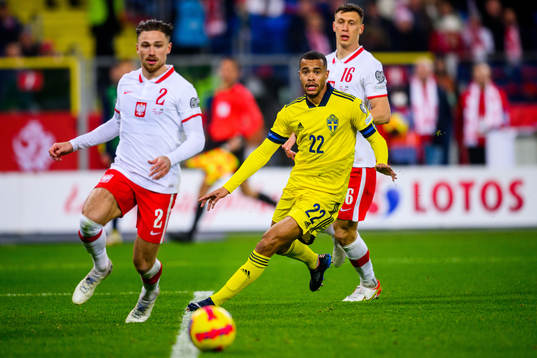 Robin Quaison of Sweden and Matty Cash and Krystian Bielik
