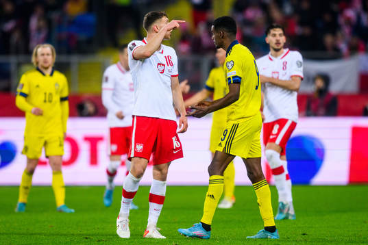 Krystian Bielik of Poland and Alexander Isak of Sweden