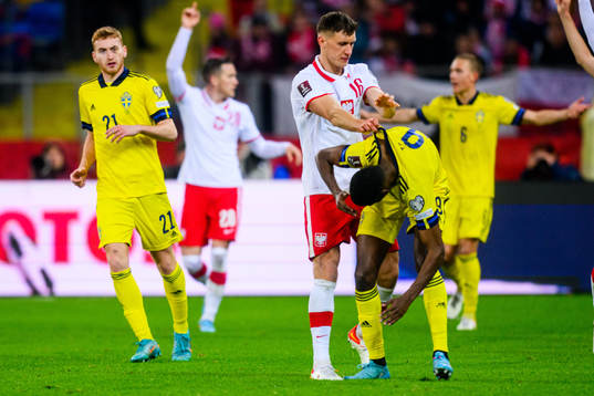 Krystian Bielik of Poland and Alexander Isak of Sweden