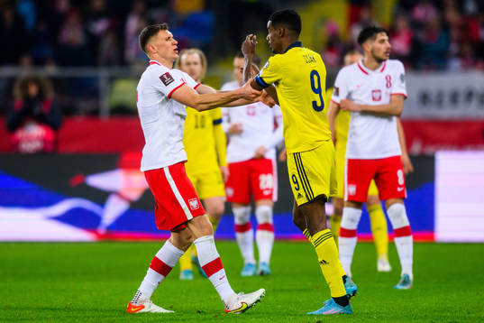 Krystian Bielik of Poland and Alexander Isak of Sweden