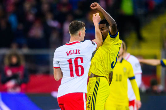 Krystian Bielik of Poland and Alexander Isak of Sweden