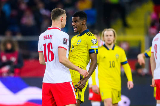 Krystian Bielik of Poland and Alexander Isak of Sweden