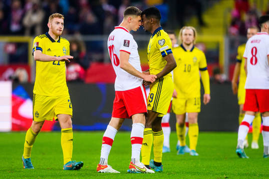Krystian Bielik of Poland and Alexander Isak of Sweden