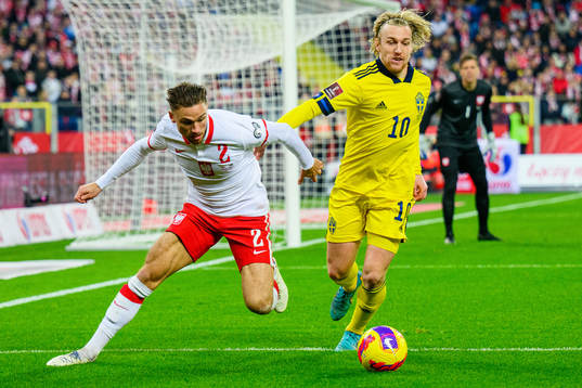 Matty Cash of Poland and Emil Forsberg of Sweden