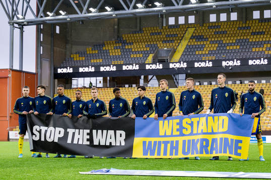 Players of Sweden with a banner