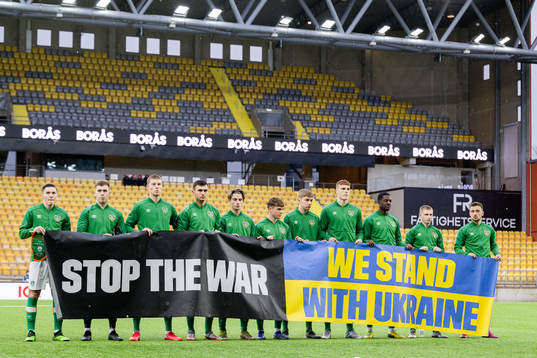 Players of Ireland with a banner