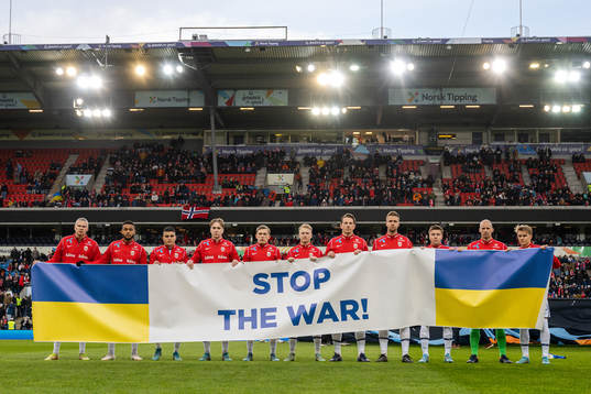 Players of Norway with a banner