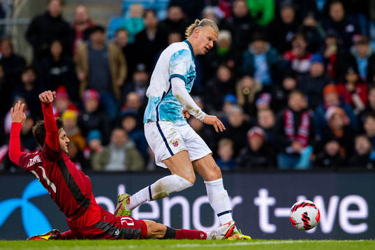 Erling Braut Haaland of Norway is being tackled by Styopa