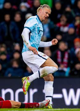 Erling Braut Haaland of Norway is being tackled as he