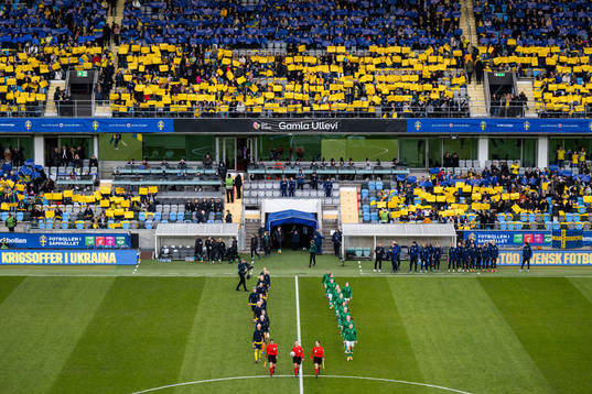 Players of Sweden and of Ireland enter the pitch