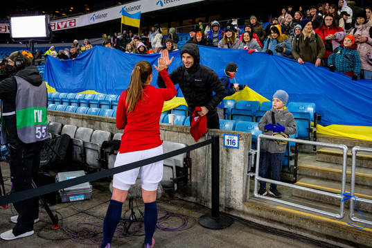 Maren Mjelde of Norway gives her kit to a supporter in the
