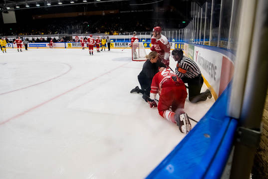 Markus Lauridsen of Denmark receives medical attention