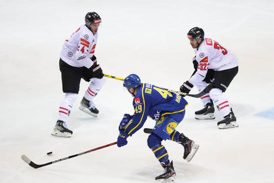Dominic Hackl and Bernd Wolf of Austria defend against