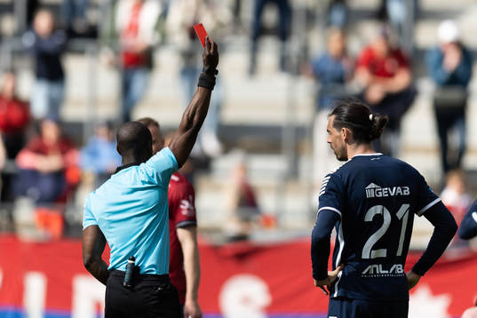 Domare Fredrik Oppong delar ut ett rött kort till